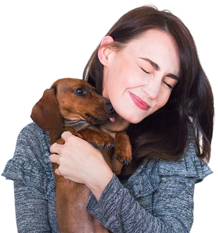 Girl hugging her puppy while learning how to house train a puppy